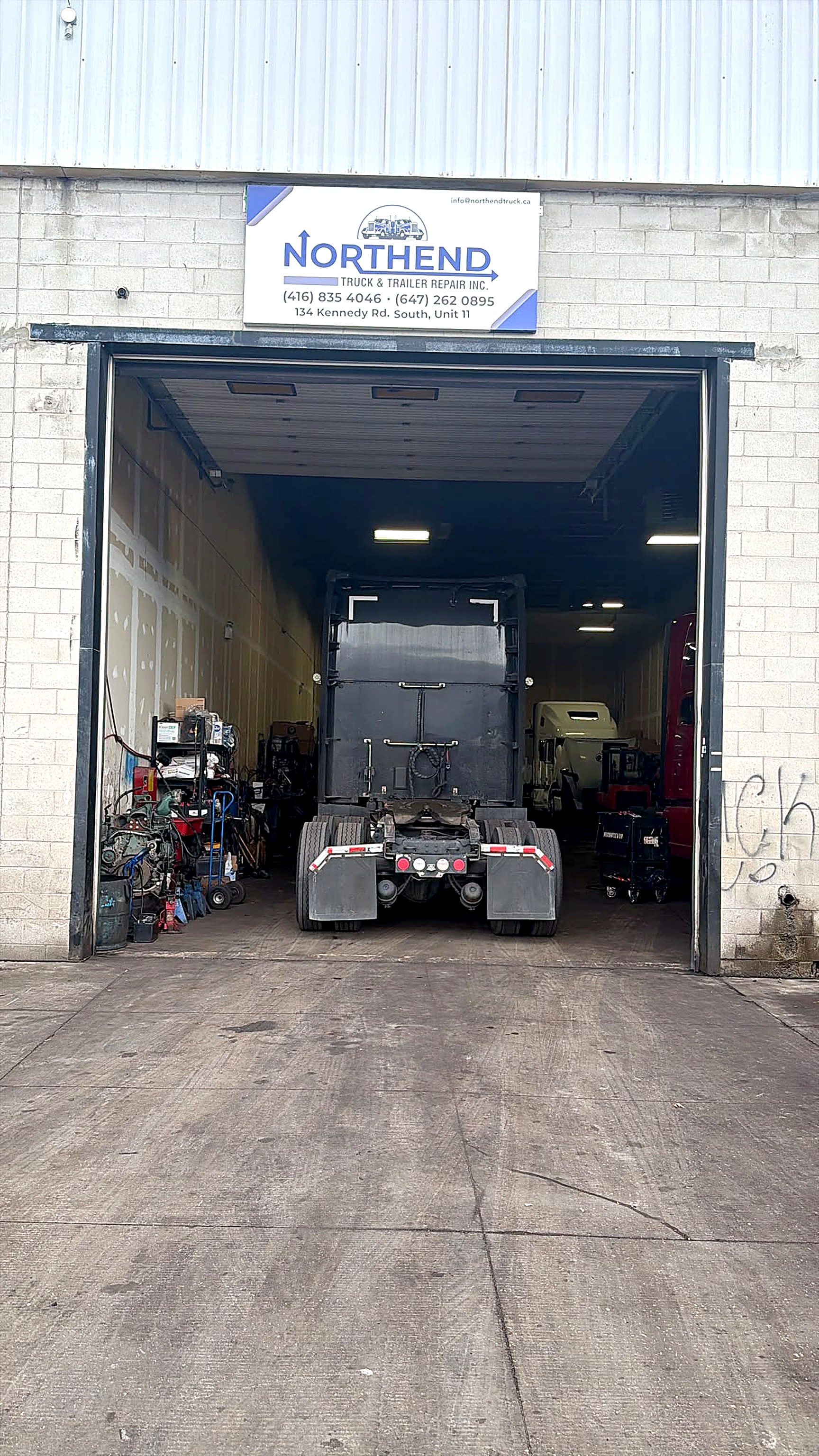 Northend shop entrance with an open service bay